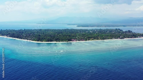 Gilli islands, Bali, aerial seascape on a foggy day. Lombok and Mount Rinjani in the background covered in the clouds photo