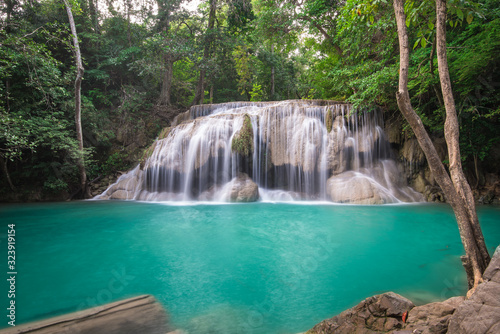 Fototapeta Naklejka Na Ścianę i Meble -  Waterfall in Tropical forest at Erawan waterfall National Park, Thailand	