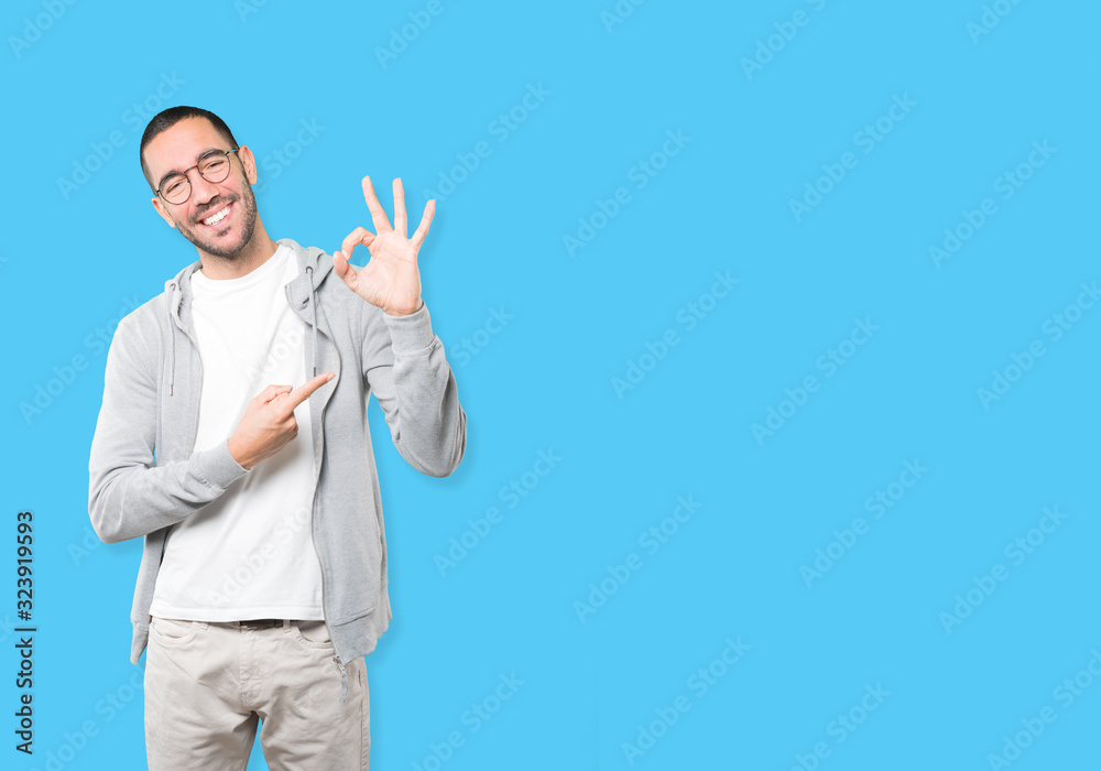 Surprised young man with a gesture of approval Surprised young man with a gesture of approval