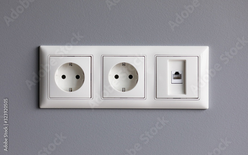 Modern white house outlet on gray wall closeup object