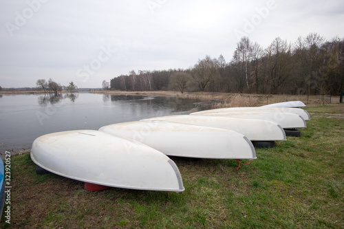 Conservated kayaks on the coast of a lake photo