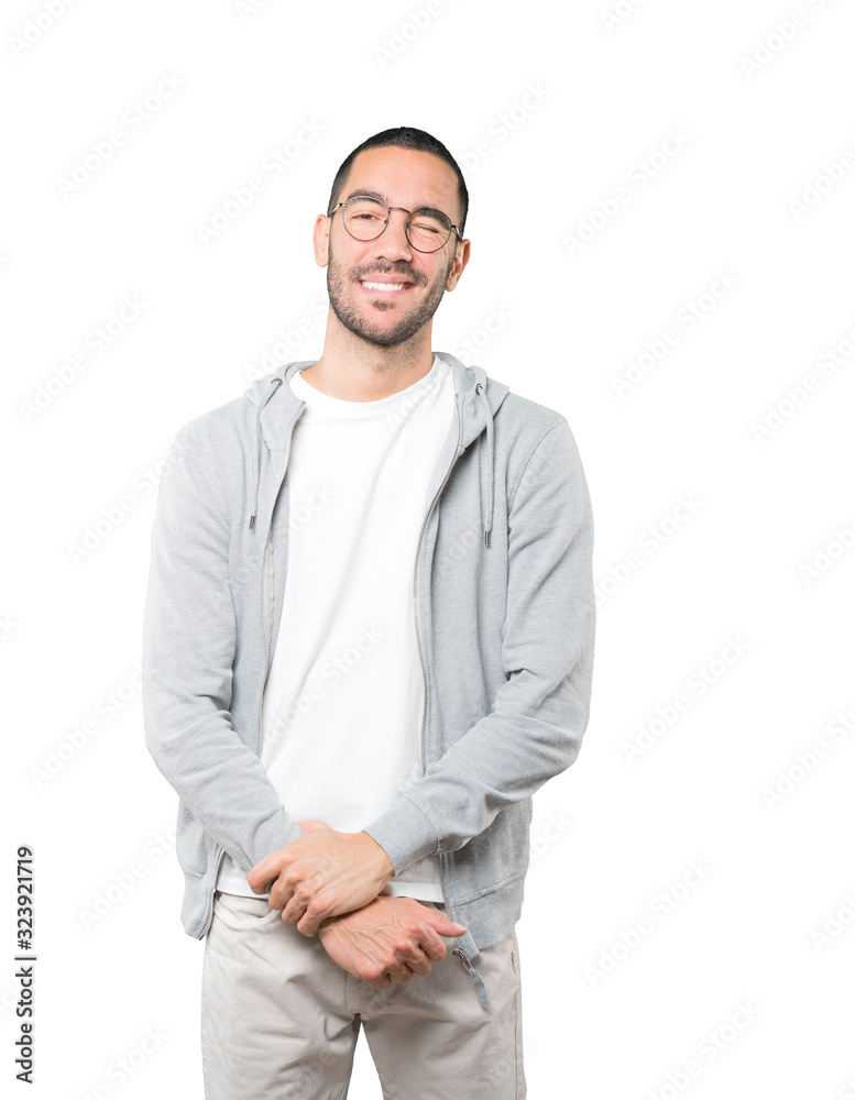 Friendly young man winking an eye Friendly young man winking an eye