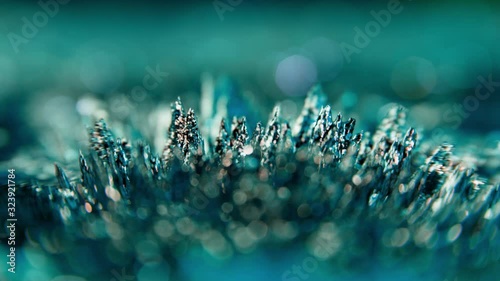 Magnetic green Iron Filings moved by magnet force