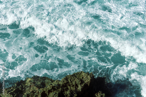 ocean waves crash against rocks