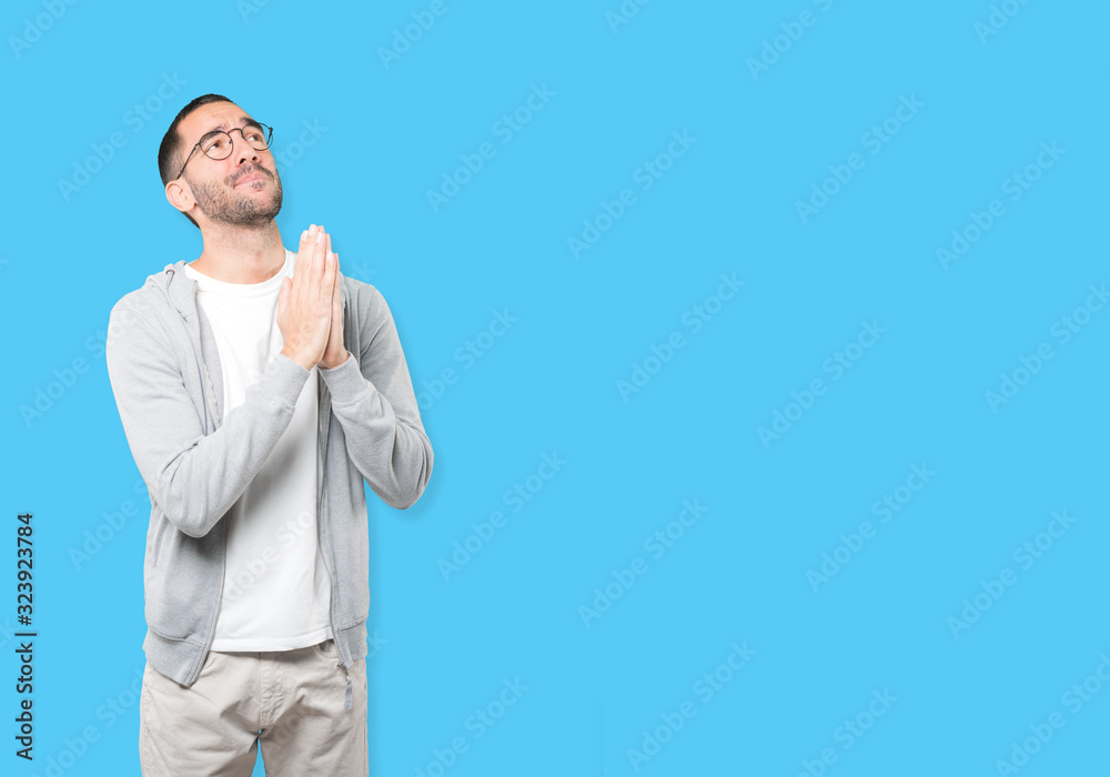 Happy young man praying gesture