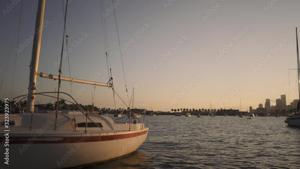 Driving by sail yacht in Miami at sunset Driving by sail yacht in Miami at sunset