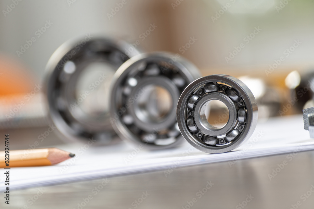 Three various ball bearings lying on paper sheet