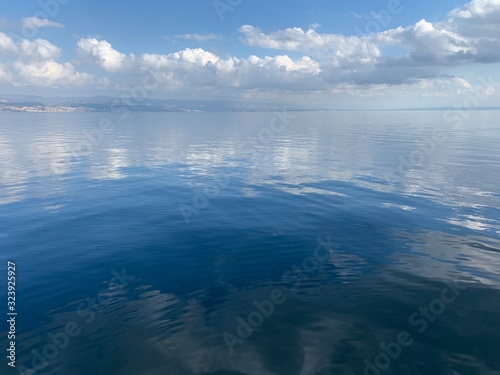 Sky reflection on the surface of the sea, natural colors photo