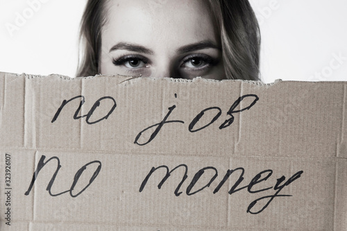 Close up depressed woman holding sign No job - no money.