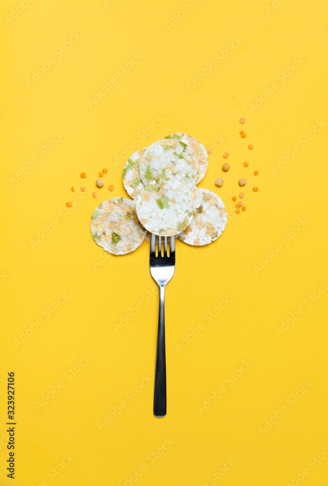 Vegeterian bean chips and lentils on yellow background. Top view. Vegeterian bean chips and lentils on yellow background. Top view.