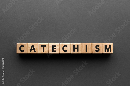 Catechism - words from wooden blocks with letters, principles of Christian religion catechism concept, top view gray background