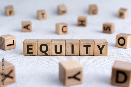 Equity - words from wooden blocks with letters, the value of a company equity concept, white background photo