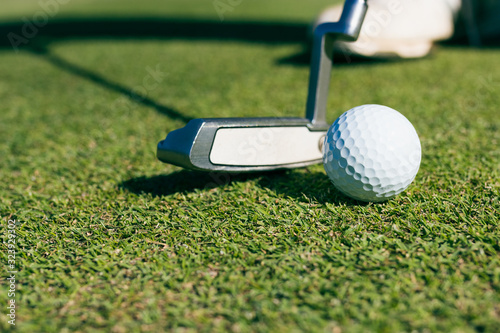 Close Up of Golf club and ball in grass.