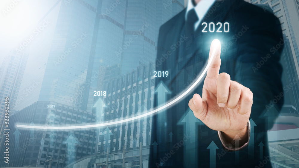 Man standing and pointing hand with Arrow and Line Visual Graphic on Light of Len flare and Boke blue background with Urban view. COPY SPACE. Business Concept : Market Uptrend and Forecast 2020 Man standing and pointing hand with Arrow and Line Visual Graphic on Light of Len flare and Boke blue background with Urban view. COPY SPACE. Business Concept : Market Uptrend and Forecast 2020