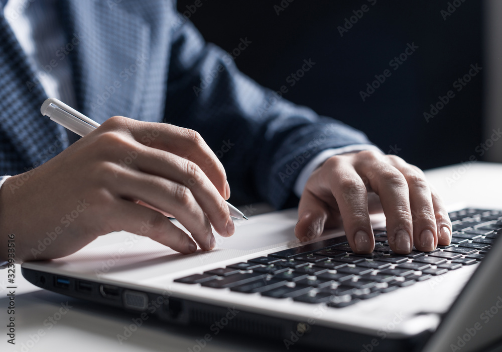 Man in business suit sitting at desk with laptop Man in business suit sitting at desk with laptop