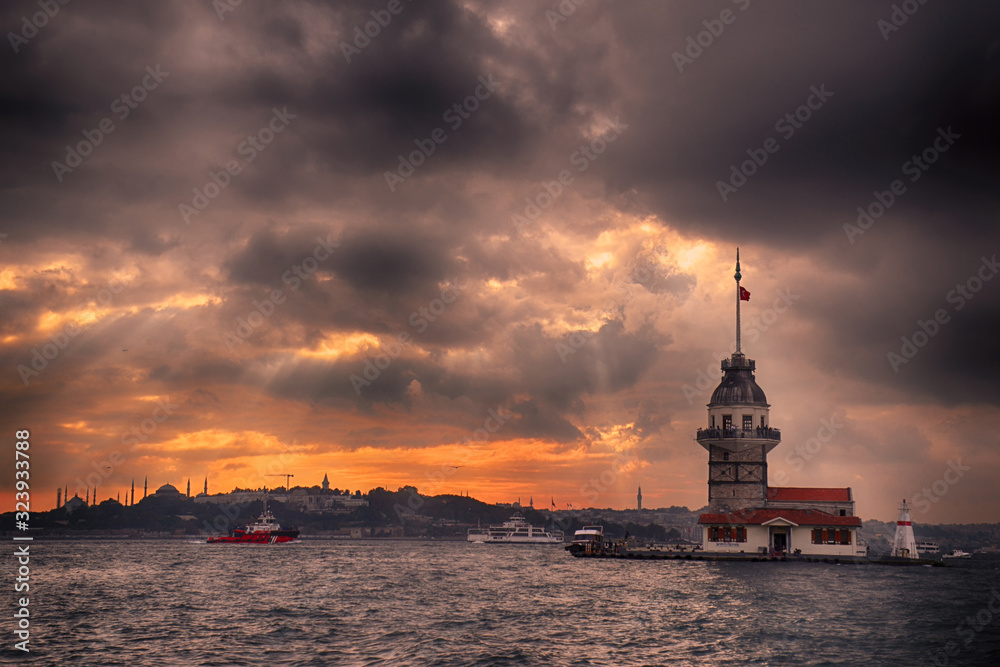Maiden's Tower and Istanbul Landscape on a cloudy day with changing lights. Maiden's Tower or Kiz Kulesi located in the middle of Bosphorus, Istanbul in Turkey.