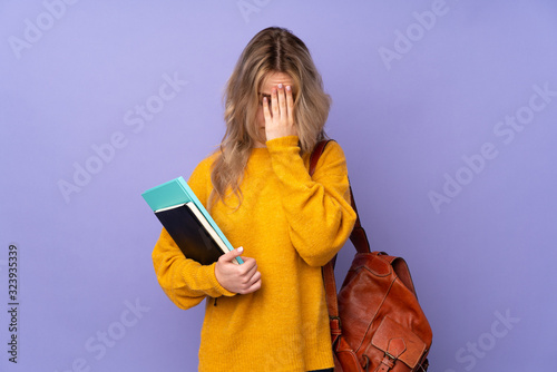 Teenager Russian student girl isolated on purple background with tired and sick expression