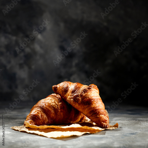 Obraz na płótnie Fresh croissant on dark mood background and copy space for your product