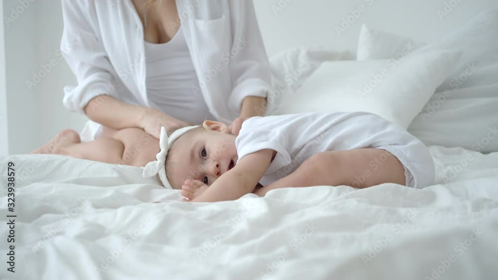 Adorable Infant Baby Girl Lying On The Bed And Having A Rest