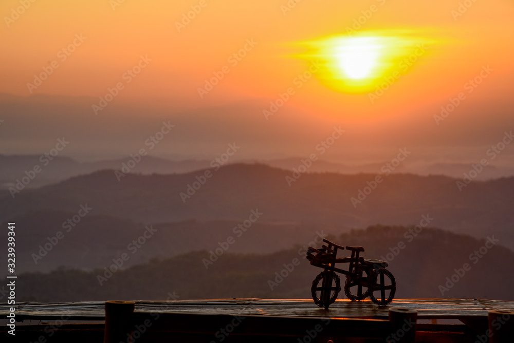 silhouette of man sitting in the mountain at sunset silhouette of man sitting in the mountain at sunset