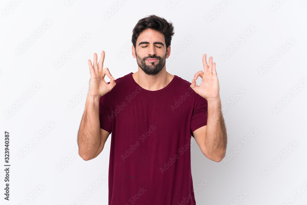 Young handsome man with beard over isolated white background in zen pose Young handsome man with beard over isolated white background in zen pose