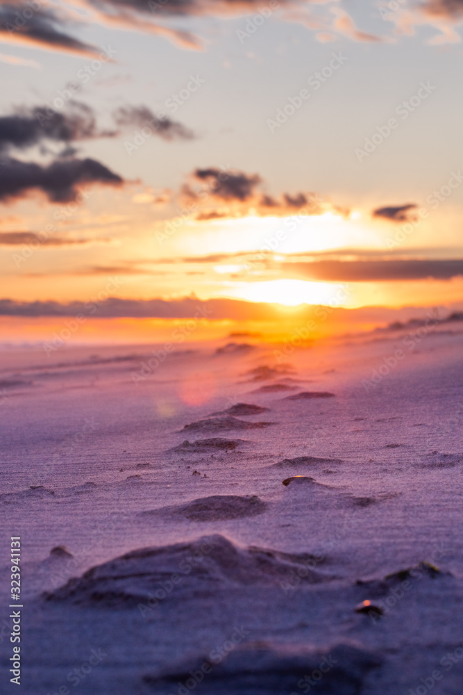 Beach Sunset Portrait with sand foot prints