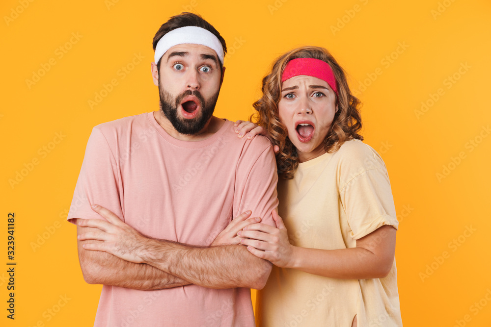 Portrait of athletic shocked couple screaming and expressing wonder Portrait of athletic shocked couple screaming and expressing wonder
