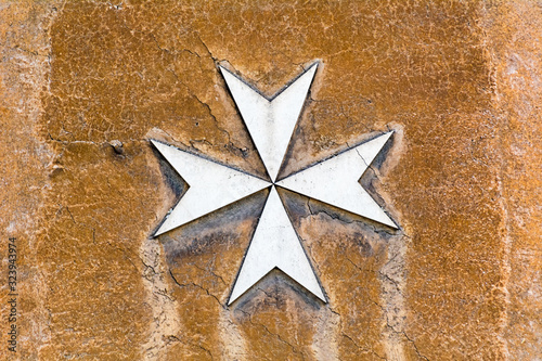 Maltese cross on the wall in Rome photo