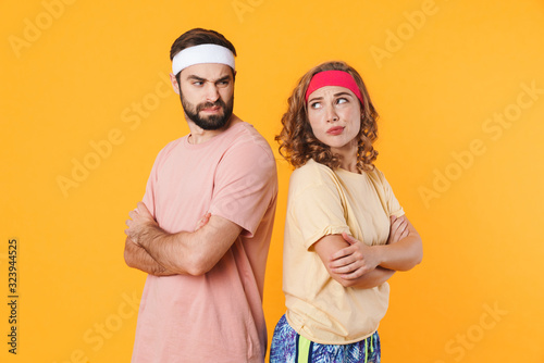 Portrait of offended couple frowning and standing with arms crossed © Drobot Dean