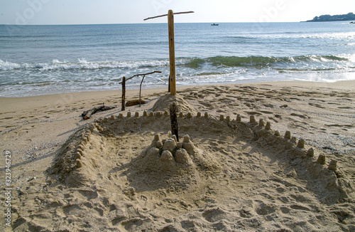 Sandy beach fortress - children's play. A lonely beach at the end of a summer day.