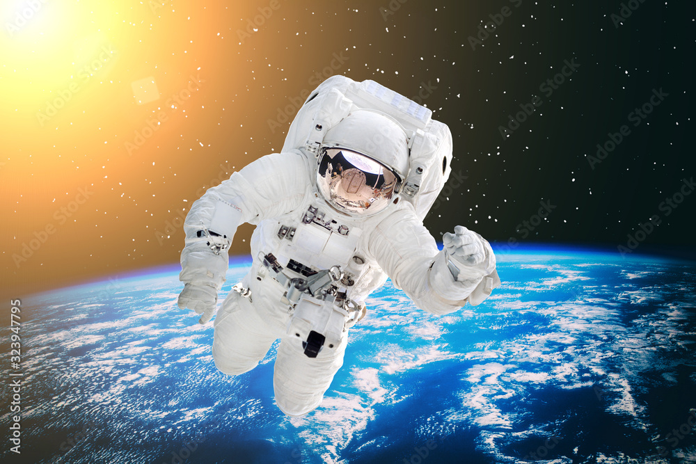 Fototapeta premium Astronaut and the earth. The elements of this image furnished by NASA.