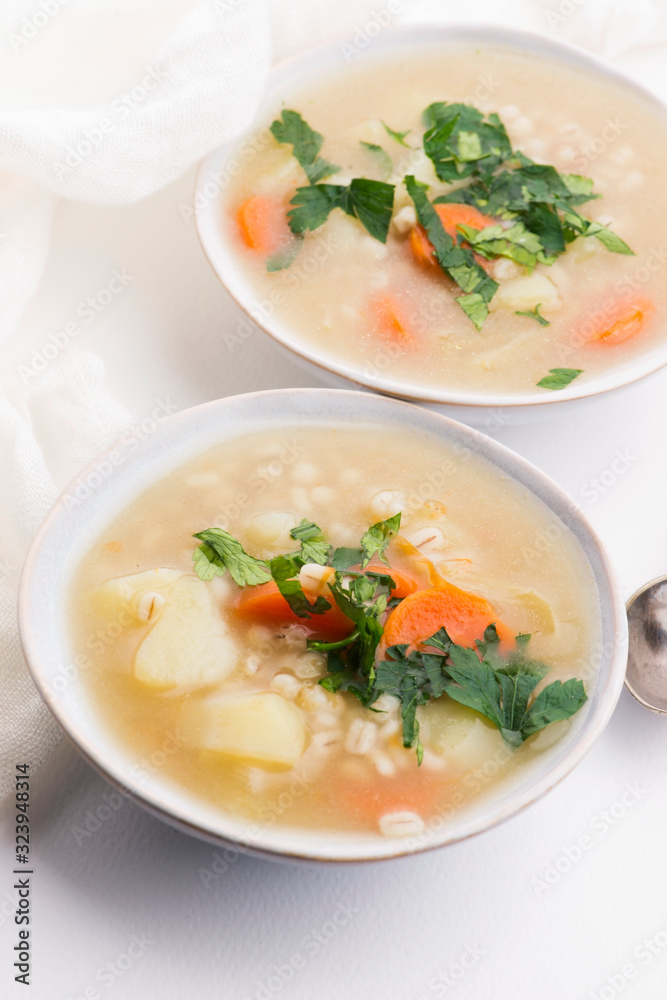 Barley soup, pearl barley in white bowl Barley soup, pearl barley in white bowl