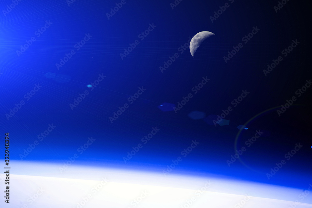 Orbital dawn from the space station. Moon. Blue glow. Elements of this image furnished by NASA.