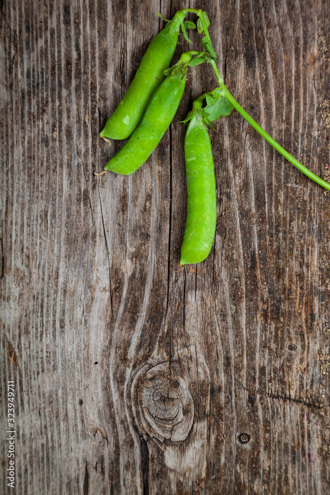 Green peas in a wooden bowl.