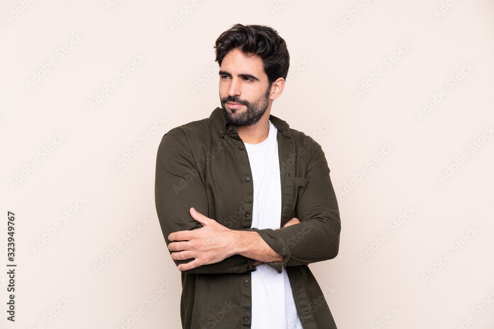 Young handsome man with beard over isolated background portrait Young handsome man with beard over isolated background portrait