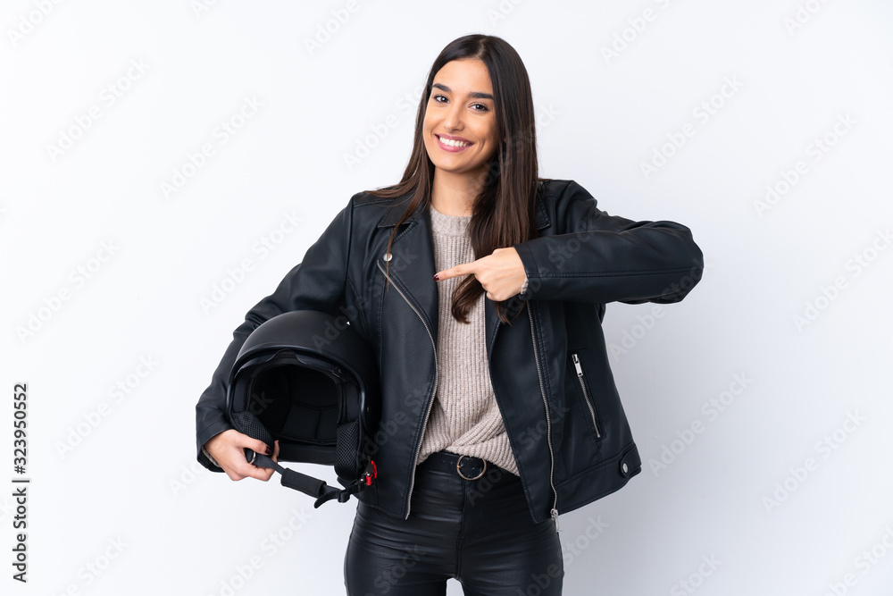Young brunette woman with a motorcycle helmet over isolated white background and pointing it Young brunette woman with a motorcycle helmet over isolated white background and pointing it