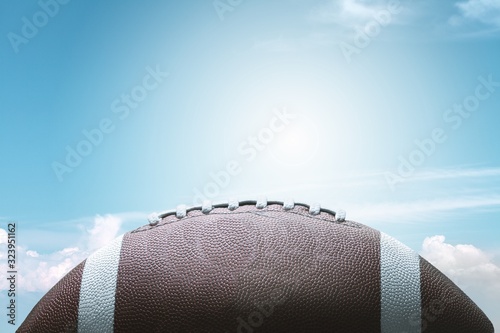 American football ball on sky background