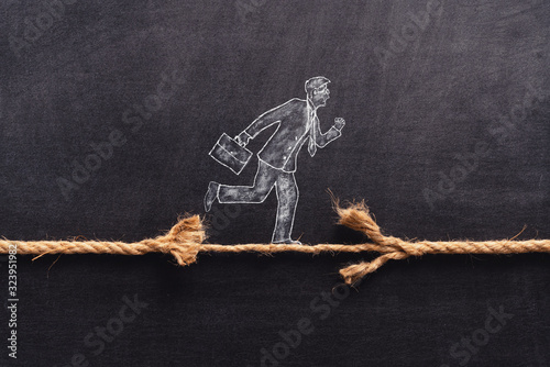 Bilde på lerret Illustrated businessman is walking on a thiny and frayed rope, metaphoring risky business life an capability of solving problems in balance