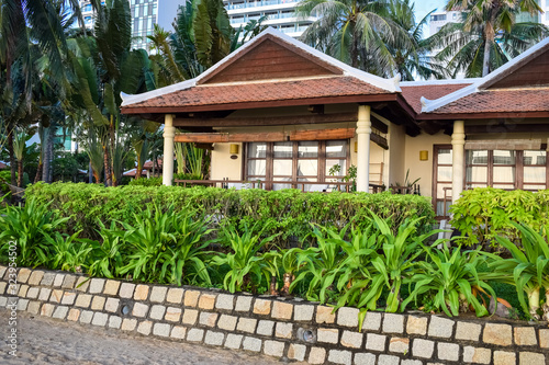 Asian beachfront buildings for tourists with green plants in the tropics
