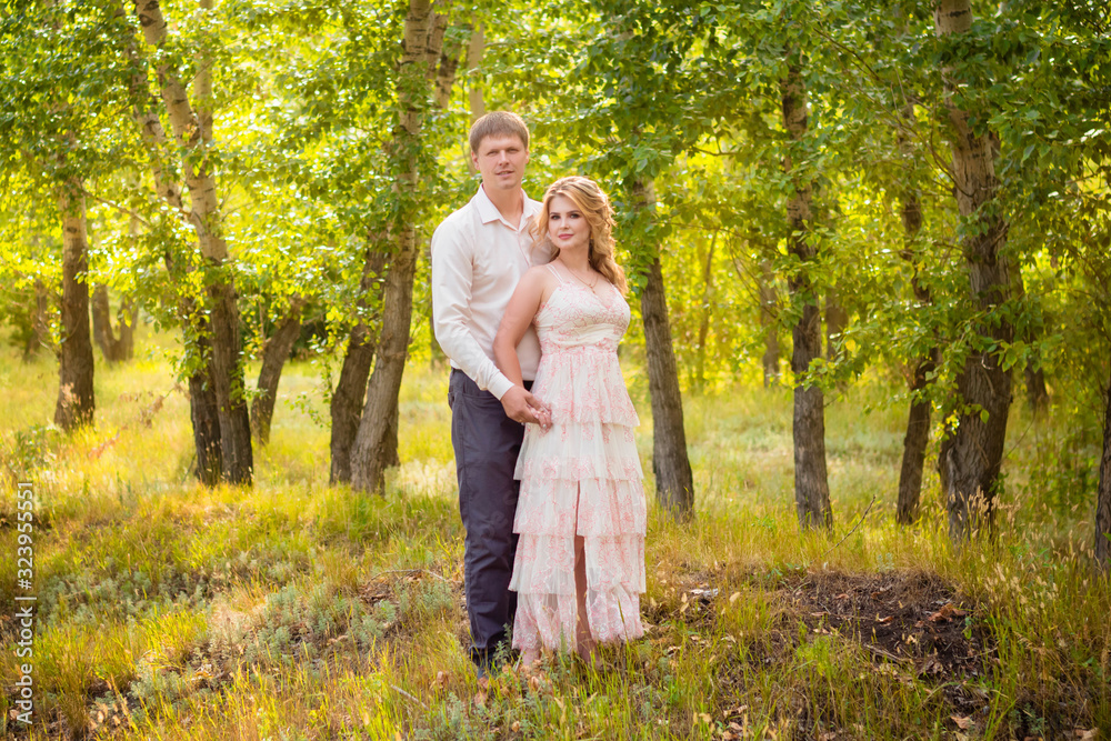 Love Story, a young couple holding hands and hugging while walking in the park. Love Story, a young couple holding hands and hugging while walking in the park.