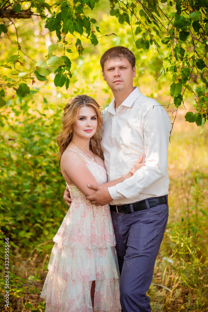 Love Story, a young couple holding hands and hugging while walking in the park. Love Story, a young couple holding hands and hugging while walking in the park.