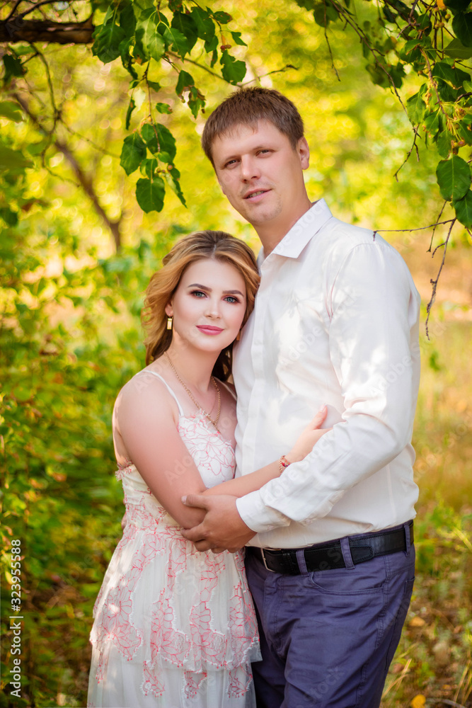 Love Story, a young couple holding hands and hugging while walking in the park. Love Story, a young couple holding hands and hugging while walking in the park.