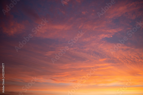 Beautiful colored cloudy skies in the colors blue, magenta, orange, purple, pink and yellow at sunrise in the Netherlands during the winter © Hulshofpictures