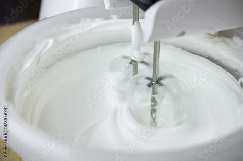 Close-up of a modern mixer making cream for making delicious pastries