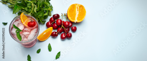 Fototapeta Naklejka Na Ścianę i Meble -  Background with cold cherries and orange  juice