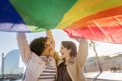 Photography two gay girls laughing with rainbow flag