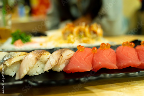 Saba and tuna sushi in a black plate