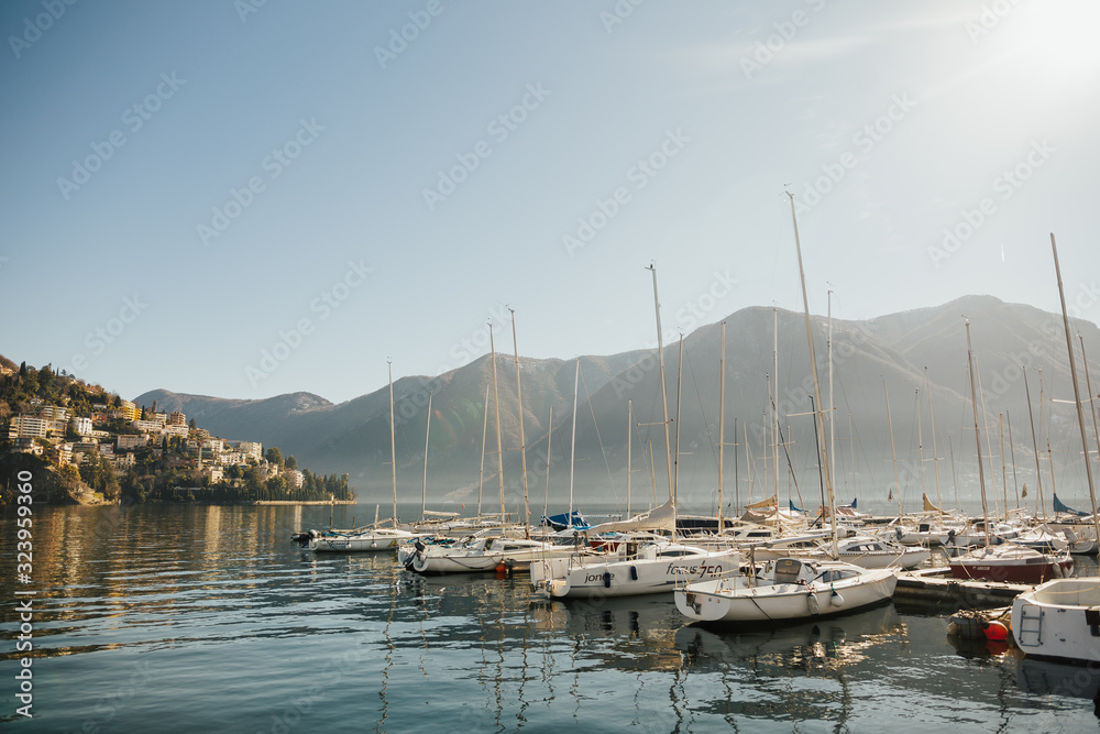 View on Lake Lugano, Monte Bre and Monte Boglia in the background. Lake Lugano is a glacial lake on the border between Switzerland and Italy. View at boats. Sunny day.
