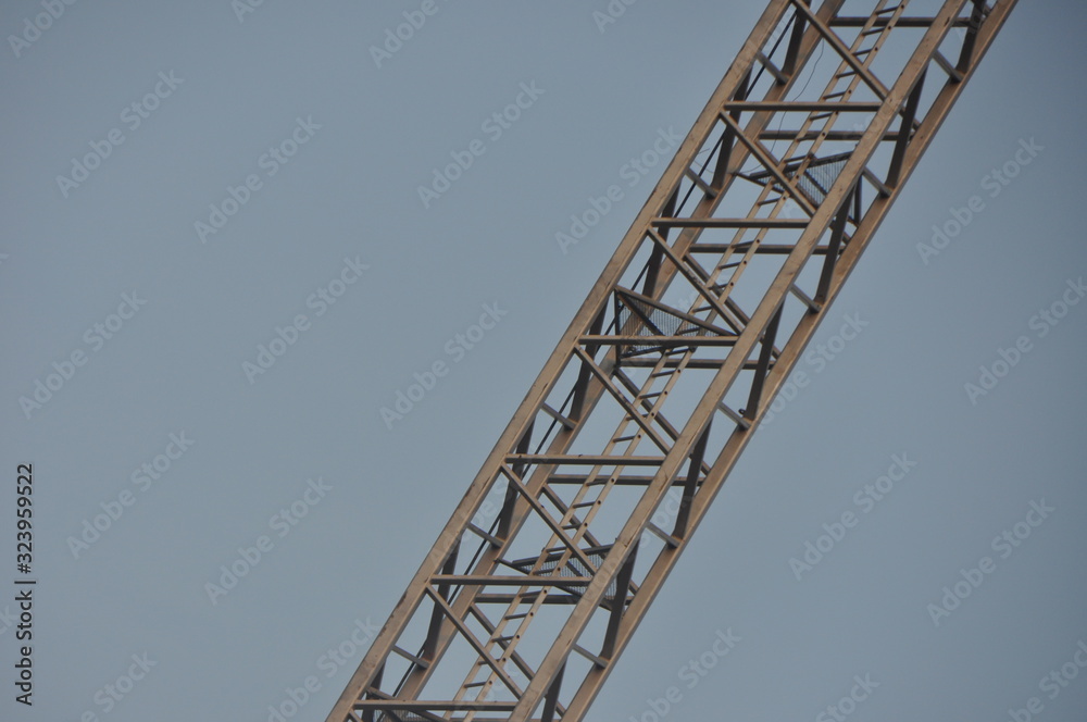 Diagonal Steel Crane Arm Against Clear Sky Diagonal Steel Crane Arm Against Clear Sky