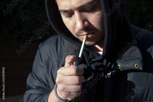 Young photographer smokes a cigarette on his break